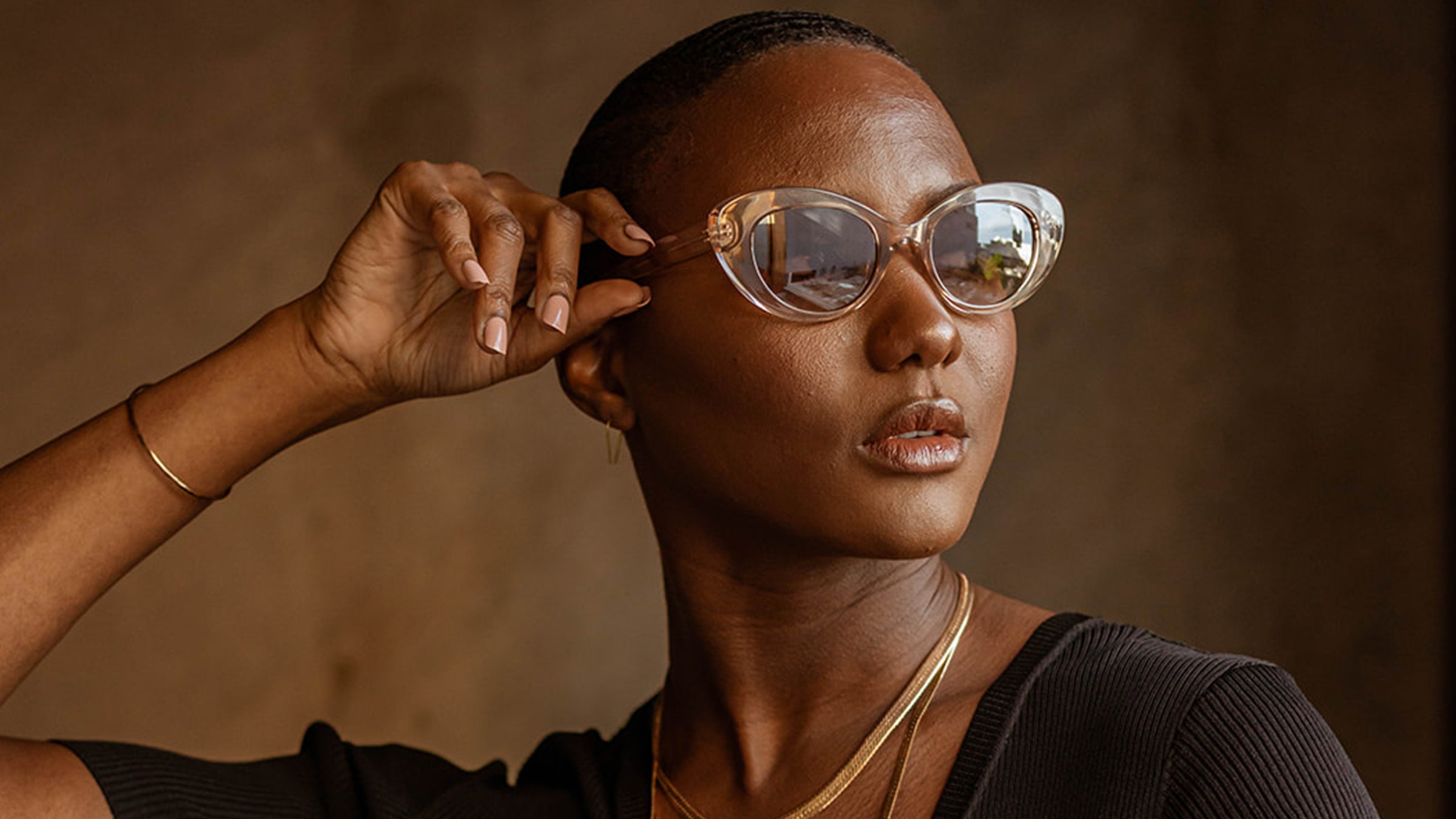 Black female model wearing New Origin Shop sunglasses