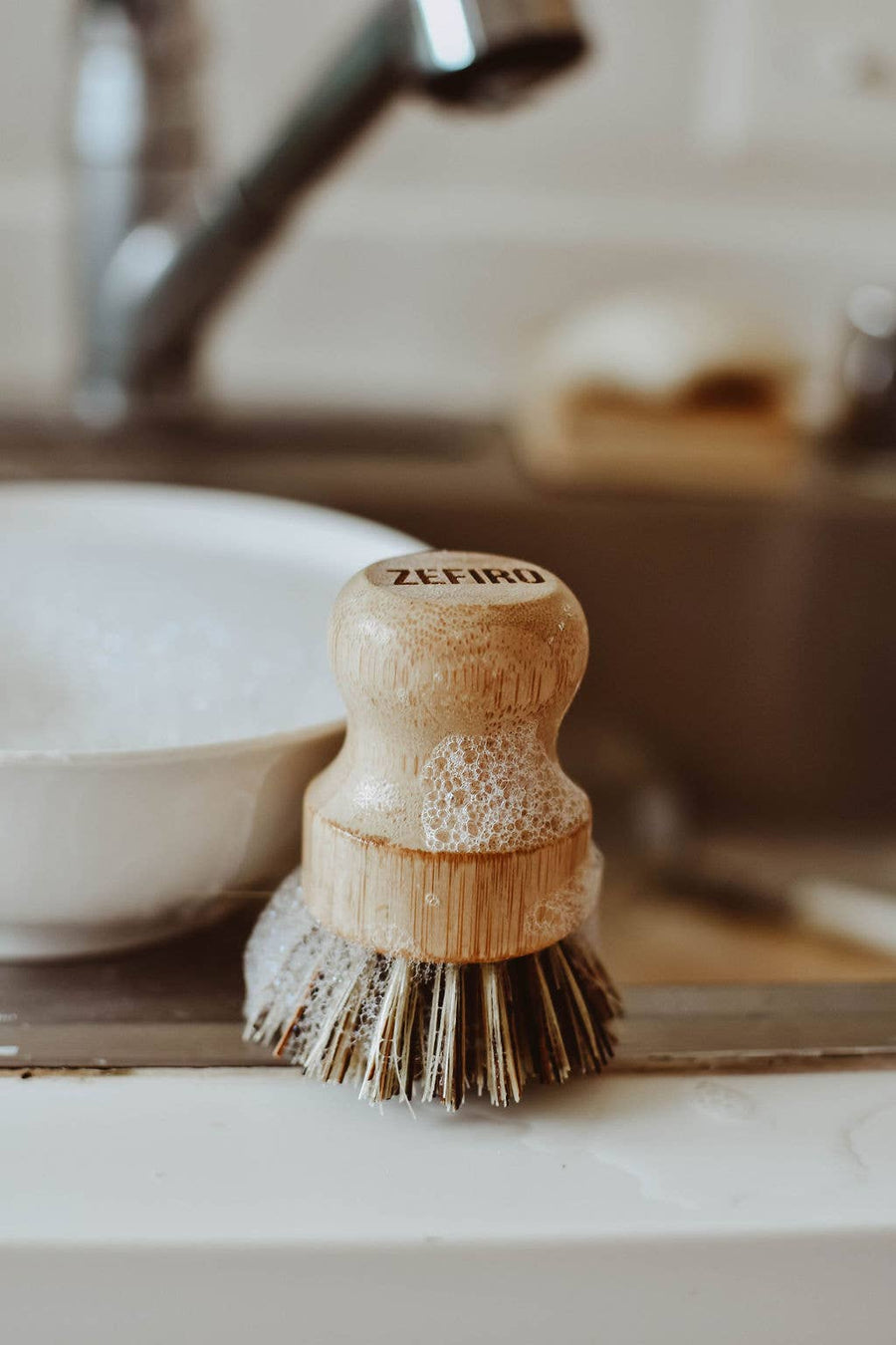 Wooden dish brush with bristles on a kitchen counter