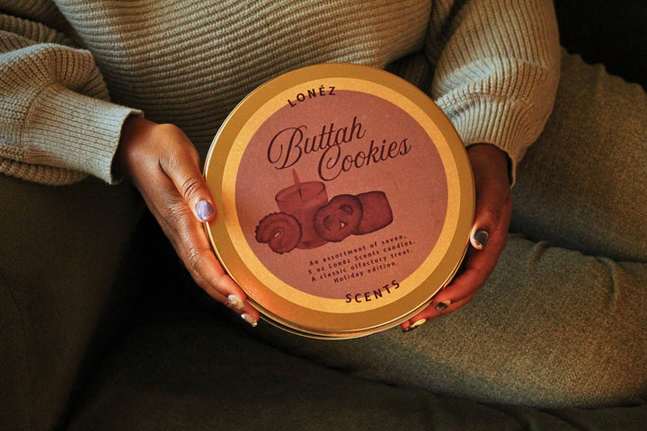 Person holding a round container labeled 'Buttah Cookies' by LONÓZ.