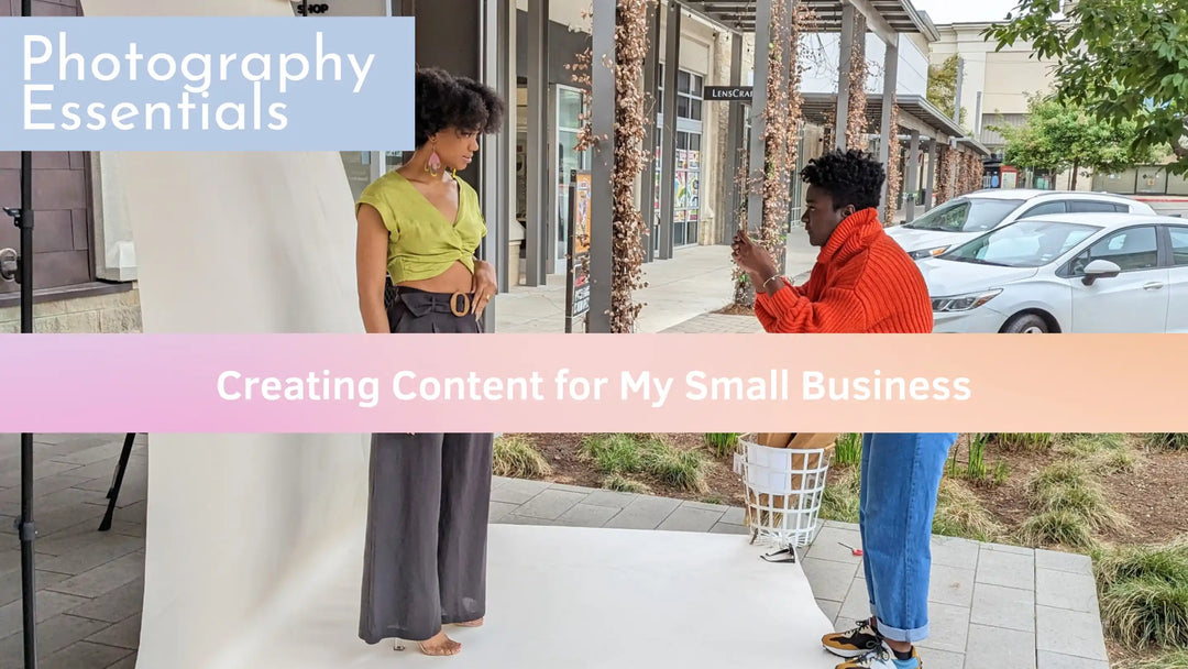 A model getting her photo taken by a black woman with a phone. The words on the screen read as Photography Essentials Creating Content for my Small Business
