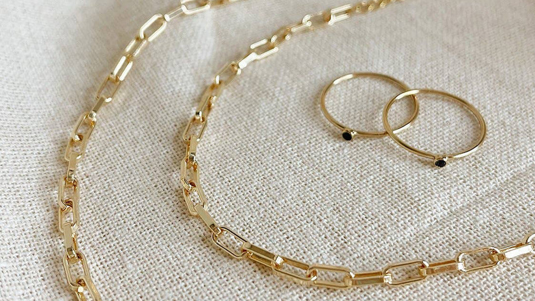Gold necklace and earrings on a cloth