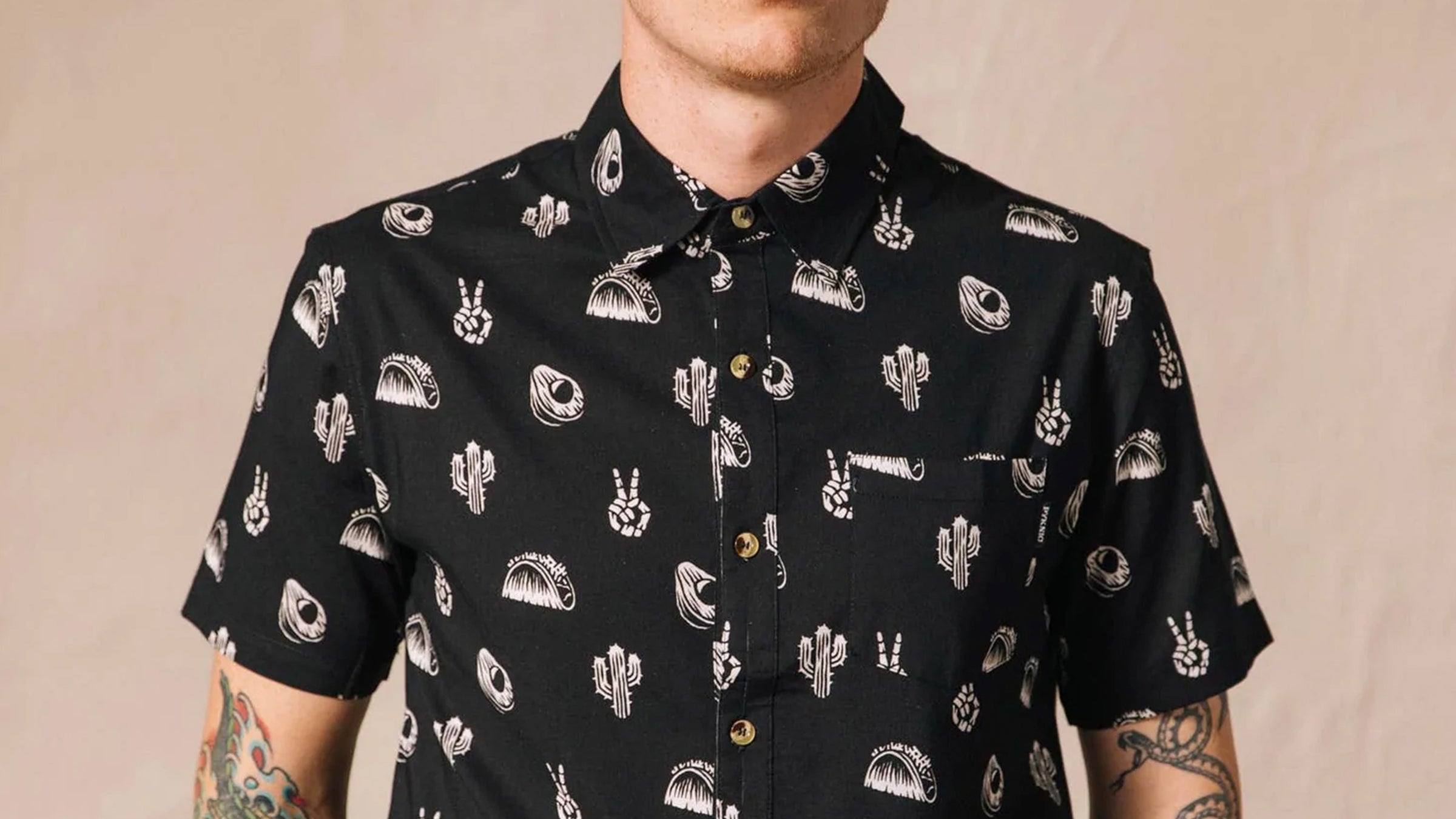 Male model wearing a black buttoned up shirt