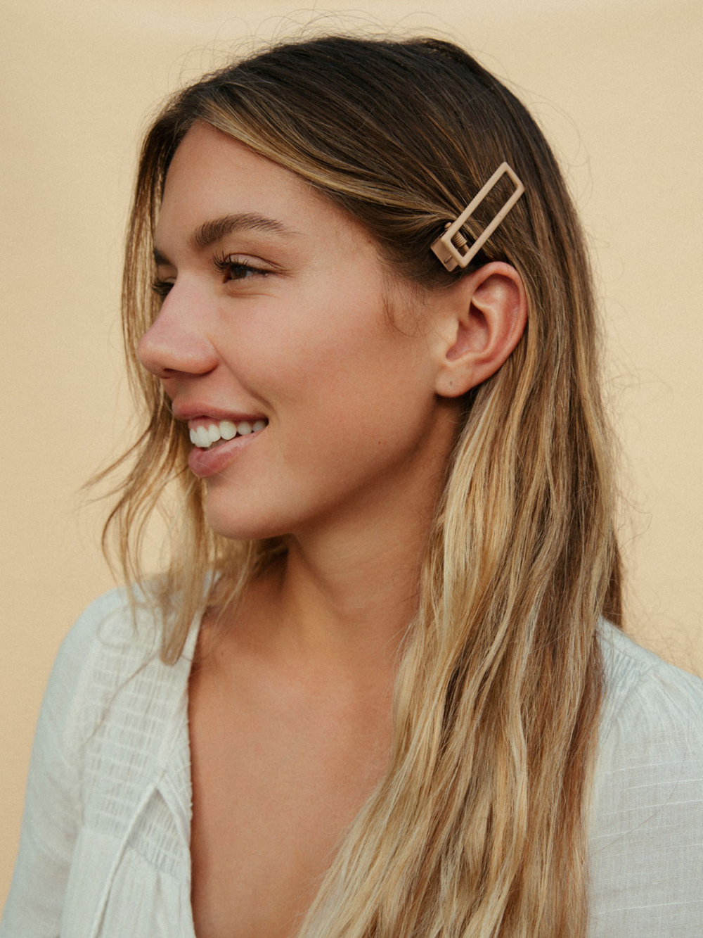 model wearing hair clips in hair as example for size reference