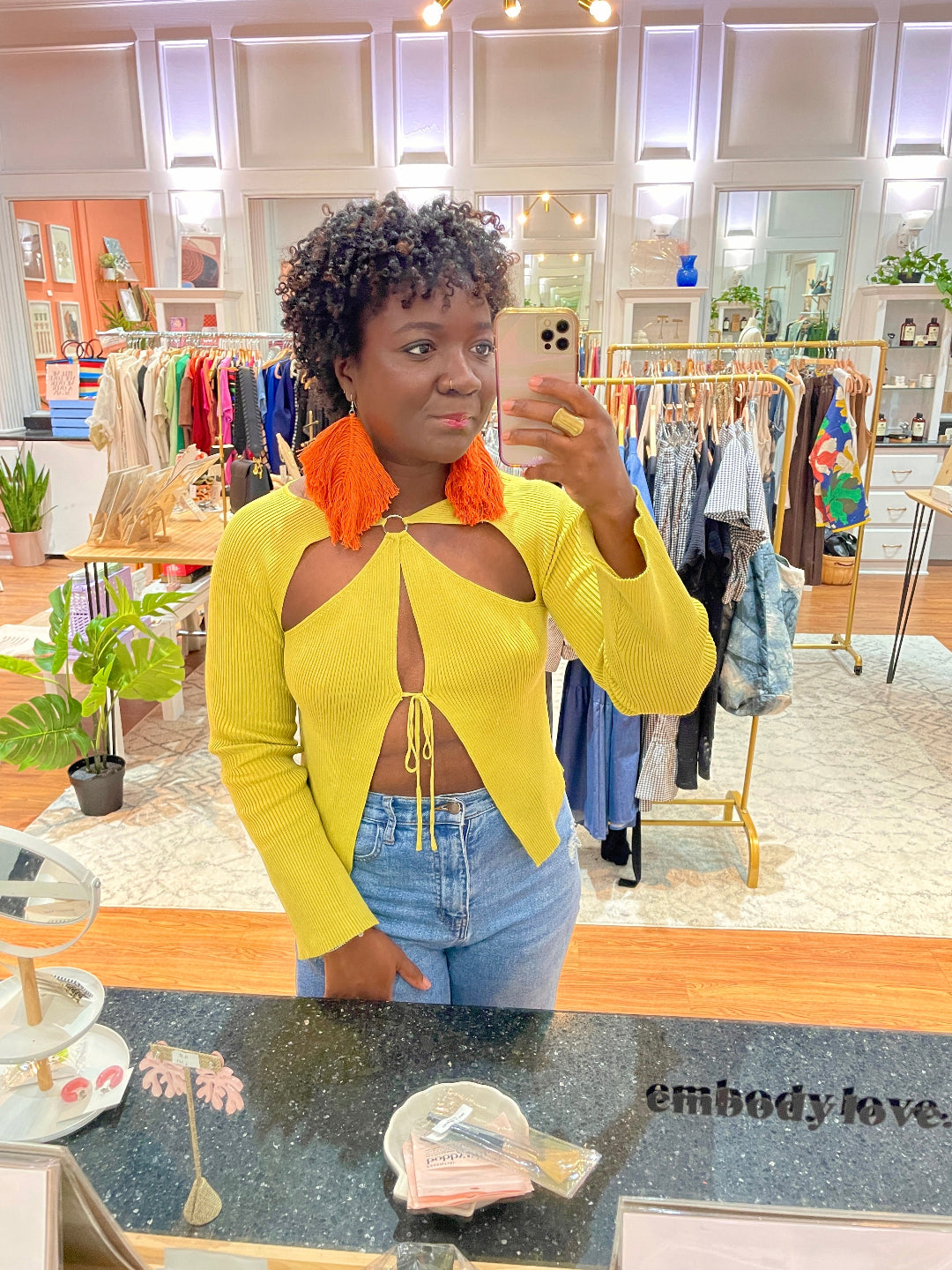 Woman taking a selfie with orange macrame earrings