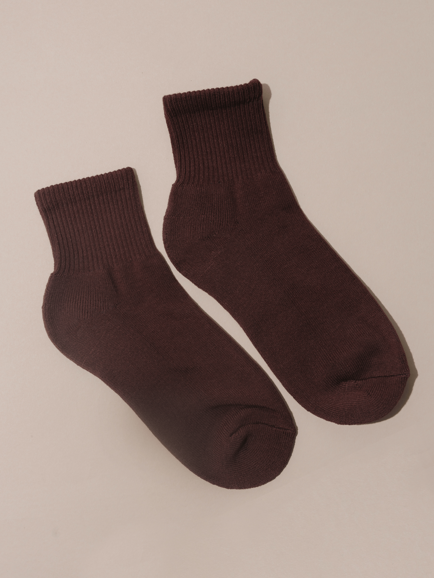 Pair of brown socks on a beige background