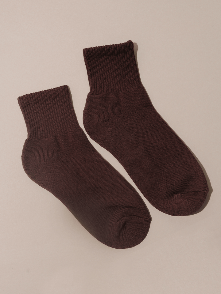Pair of brown socks on a beige background