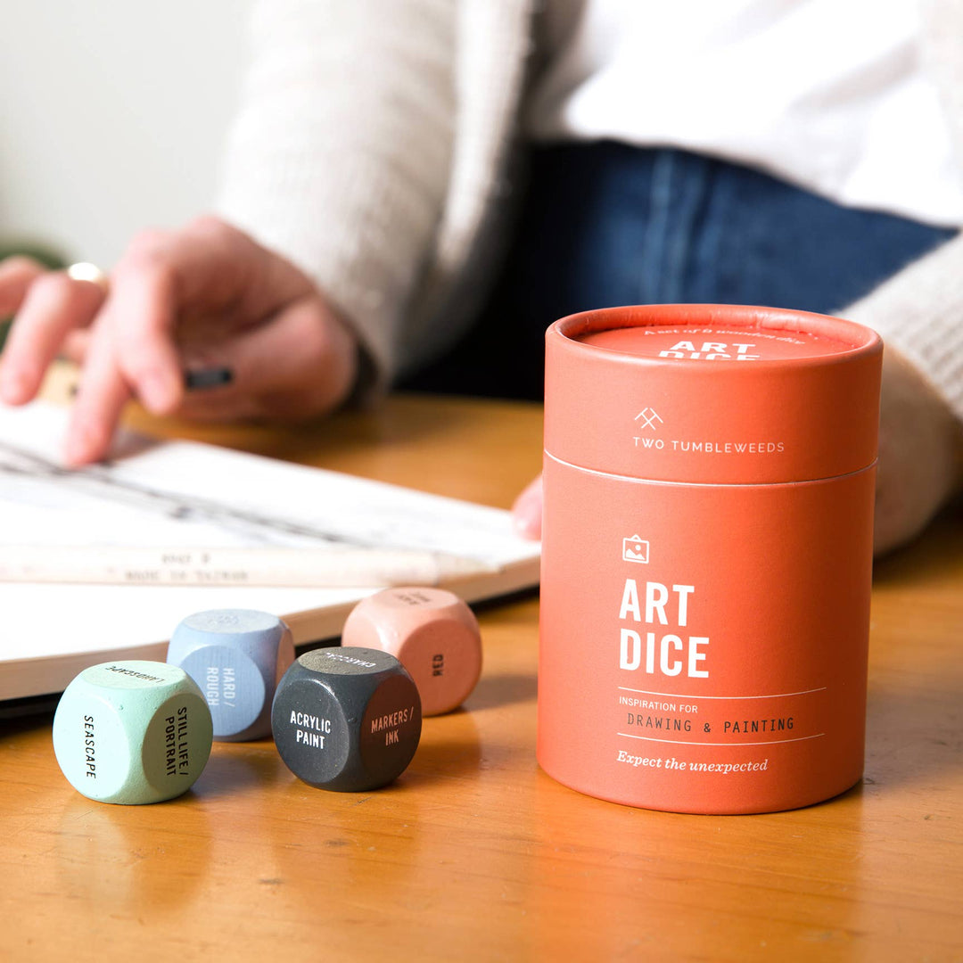 Art dice set with a canister labeled 'Art Dice' on a wooden surface.