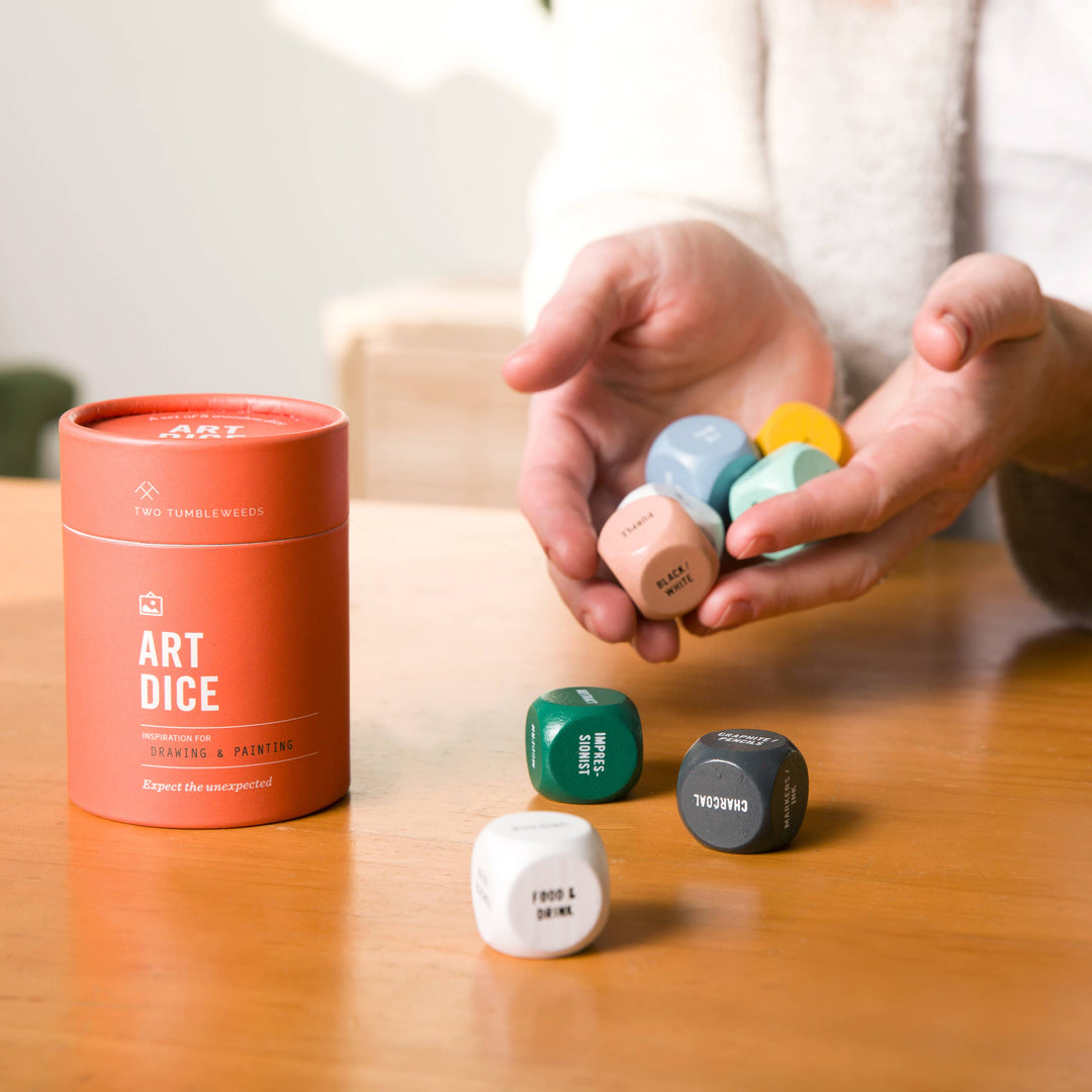 Art dice set with a canister labeled 'Art Dice' on a wooden surface.