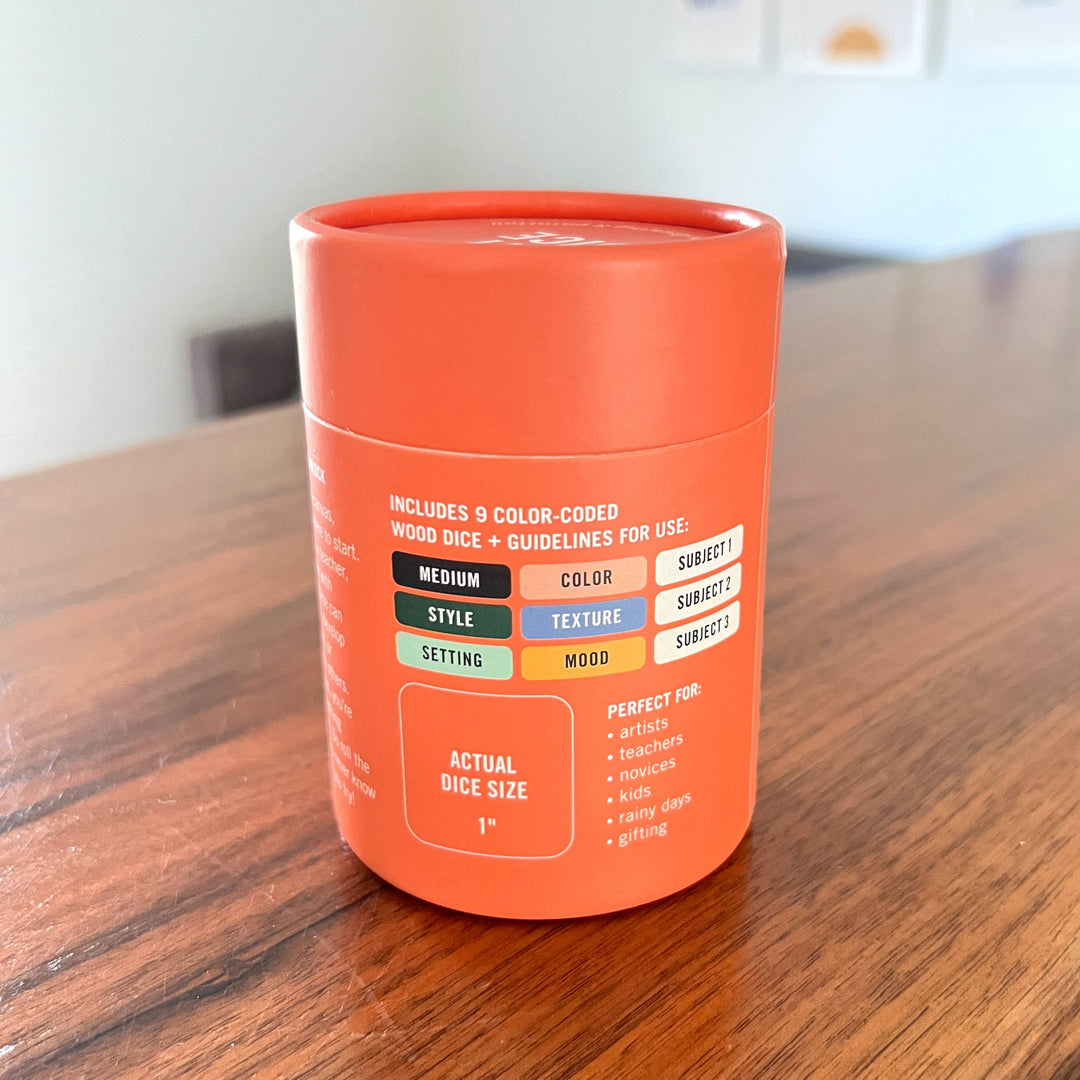 Orange dice container with text on a wooden surface