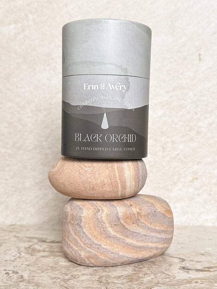 Candle in a gray container labeled &
