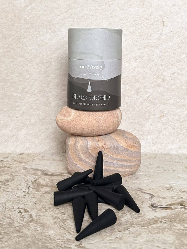 incense with packaging and black cones on a textured surface
