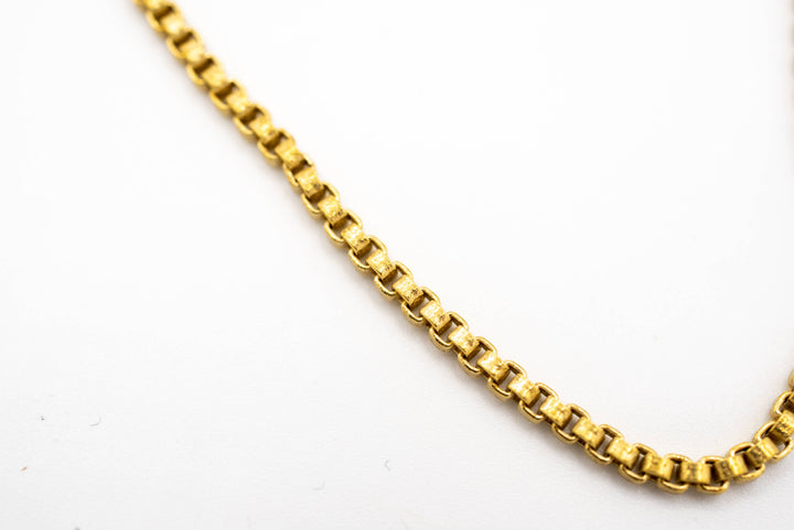 close up of brass chain on a white background