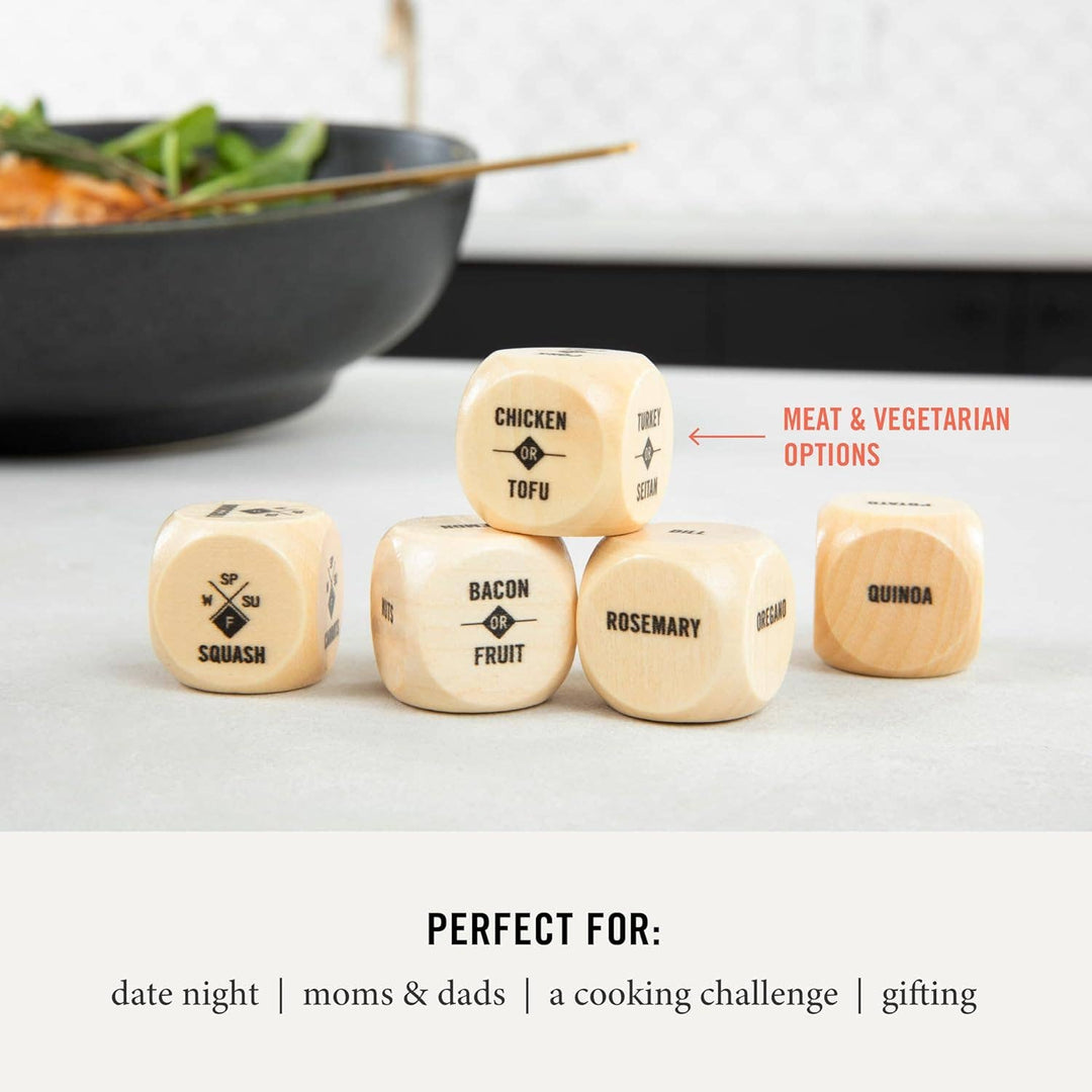 Wooden dice with food-related text on a white surface with a blurred background