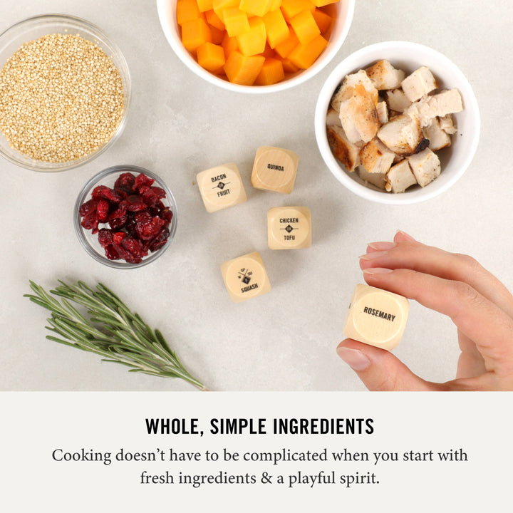 Ingredients including quinoa, dried cranberries, and chicken pieces on a light surface with text about fresh ingredients.