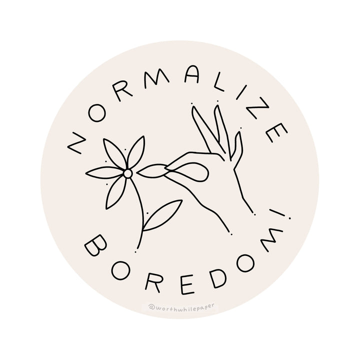 Circular sticker with hand-drawn elements and text 'Normalize Boredom' on a light pink background.