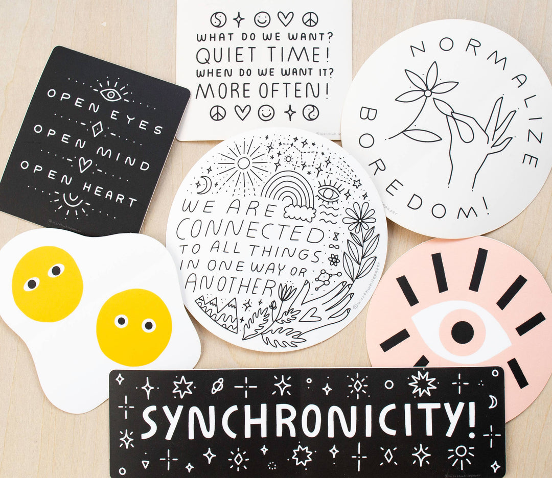 Collection of motivational and philosophical stickers on a wooden surface