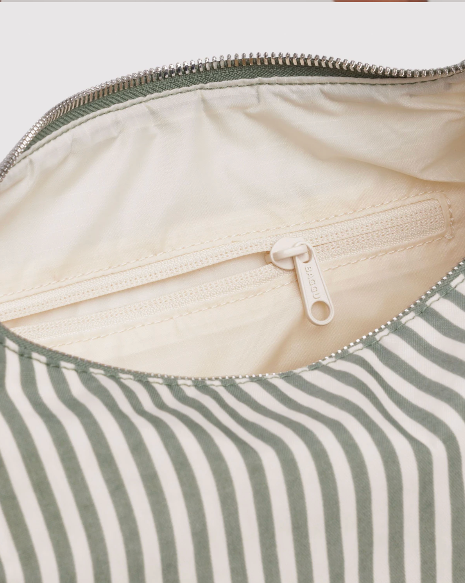 Close-up of a striped fabric with a zipper, showing the interior lining.