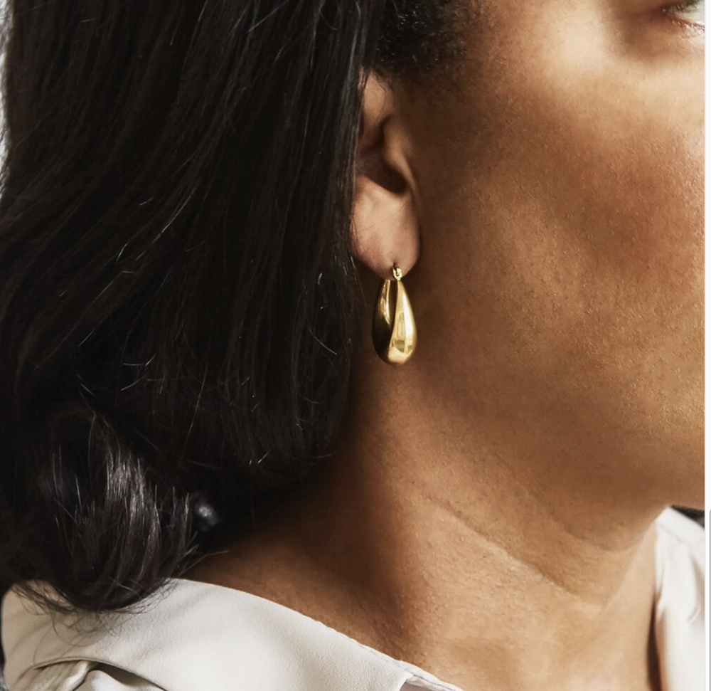 Be bold in this pair of oval hoop earrings. These beautiful earrings are made hollow for a lightweight but 'heavy-looking" feel. Perfect for an everyday look that can be stacked with our other tiny studs. Latch-Back Weight: Light Weight. Material: Gold Plated; Stainless Steel. Dimensions: Length: Approx. 25mm; Width: Approx 15mm Color: Gold. Hypoallergenic Tarnish Resistant Lead-Free; Nickel Free