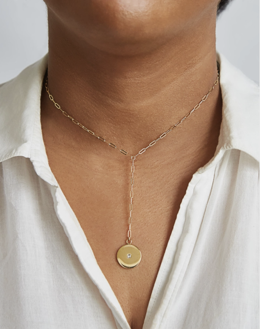new origin shop A unique take on the classic lariat necklace – featuring a gold pave disc coin pendant with an unique link style bar chain. Spring Clasp. Weight: Light Weight. Material: Chain: 14kt Gold Filled; Pendant: Gold Plated Dimensions: Approx. Chain: 14″ with 2″ extender ; Lariat: 3″ Pendant:15mm Color: Gold. Hypoallergenic