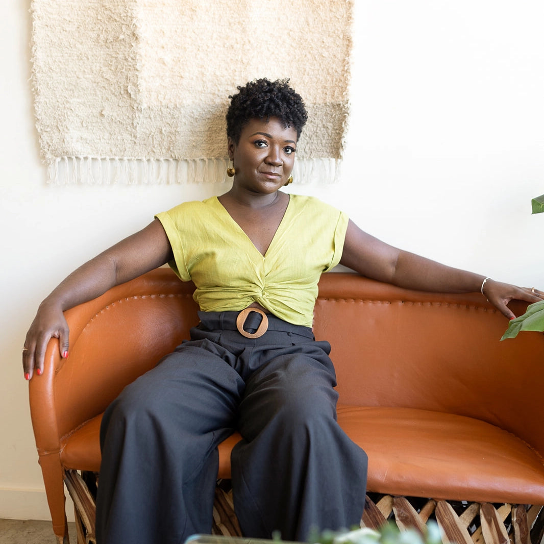 Sierra Lewis sitting on a brown couch