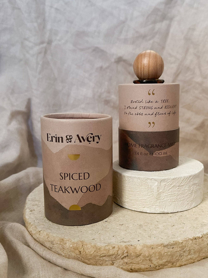 A spiced teawood scented room spray set by Erin &amp; Avery, featuring a cylindrical tin candle labeled &