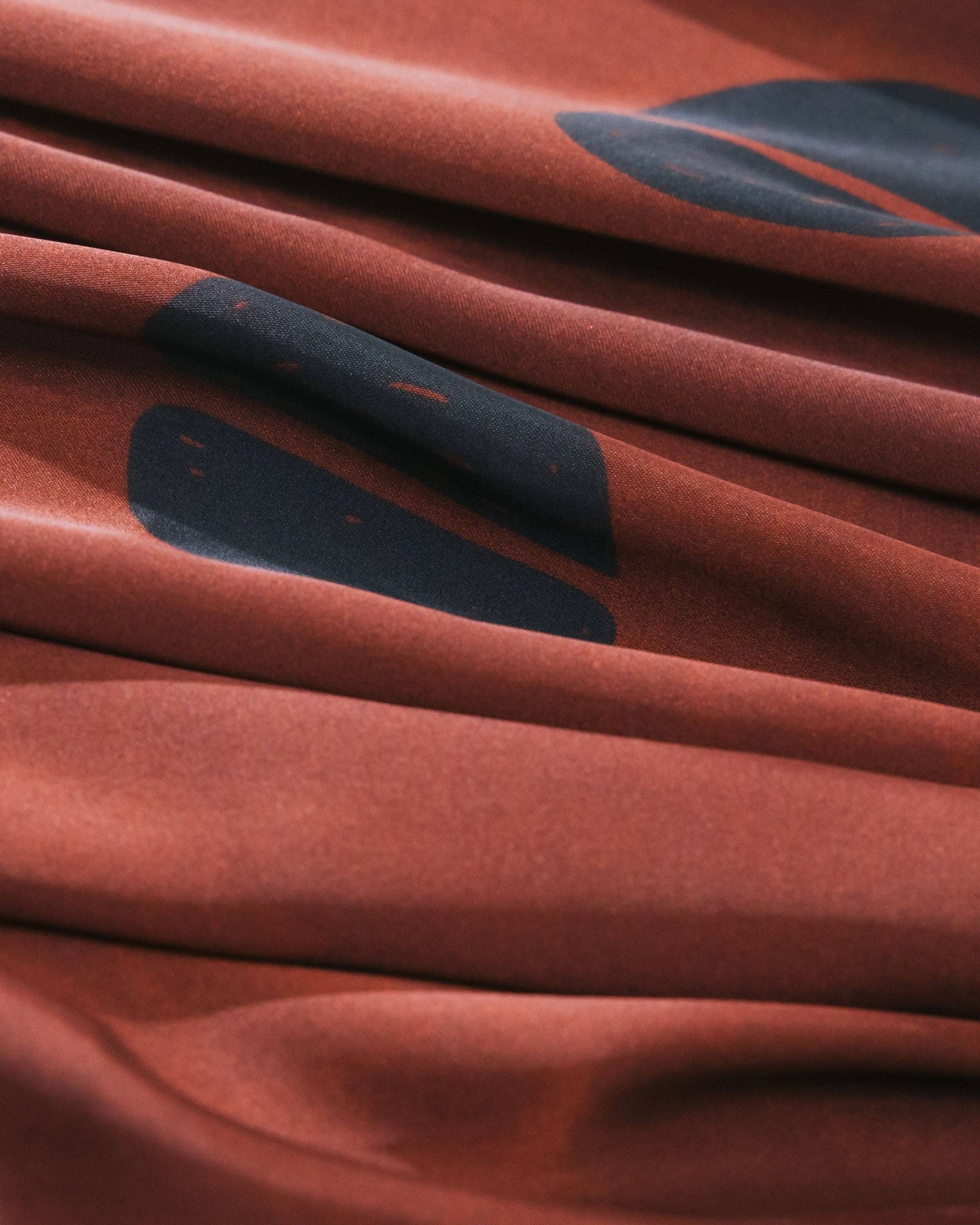 The Wrap Life - Satin Head Scarf in Mahogany: Brown in austin texas close up of brown background and black shapes