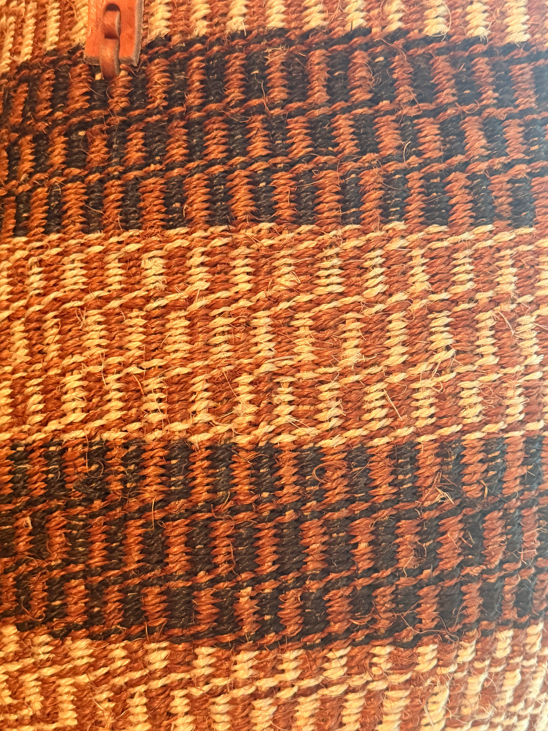 Close-up of a woven bag with brown and black pattern