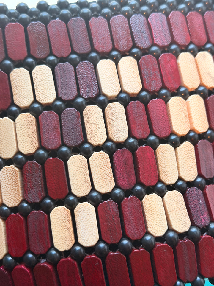 Color swatch card with various shades of red, brown, and beige on a black background