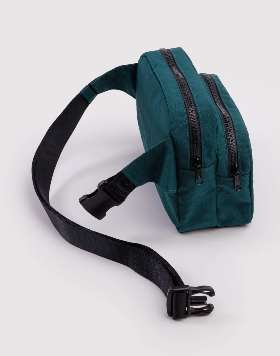 Green waist bag with a black strap on a white background