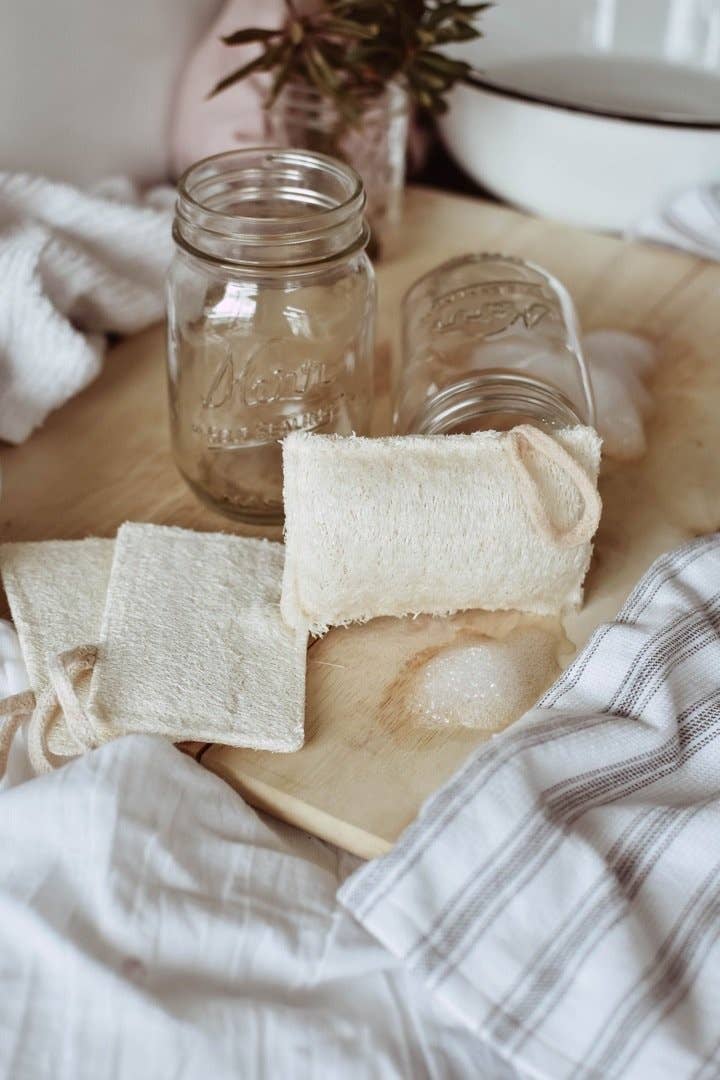 photo of hand over bowl with decor in background holding Kitchen Loofah Sponge 4