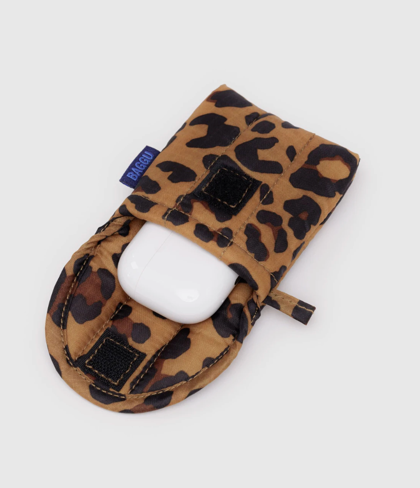 Leopard print case with a ear bud case  inside on a light gray background