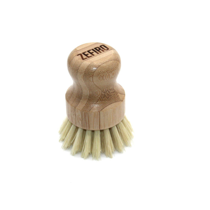Bamboo dish brush with bristles on a white background