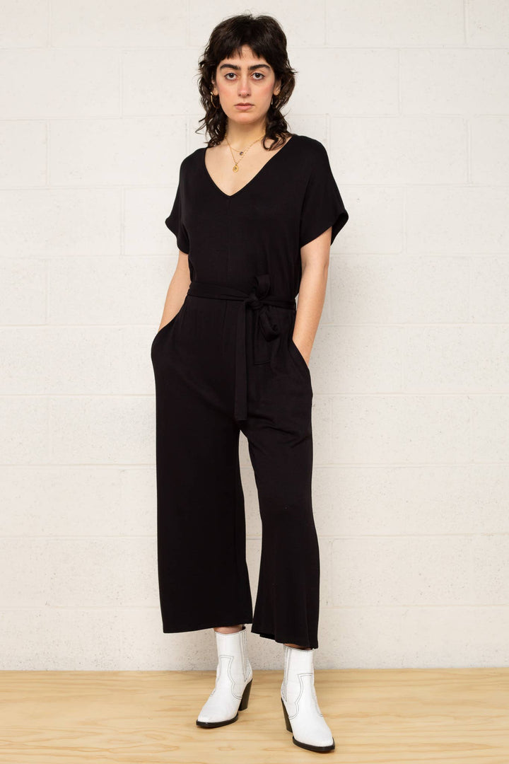 Heavy knit black jumpsuit with self-tie belt and pockets.  Model is 5'8" and wearing a Small.  Tumble dry low or lay flat to dry.  Runs closer to large in size