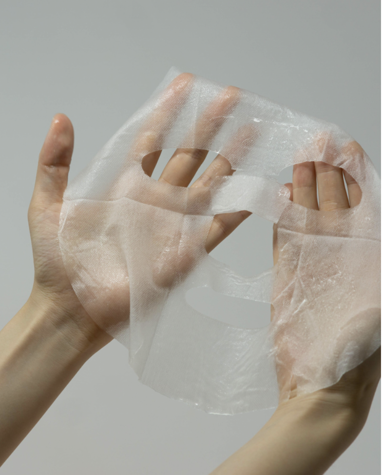 aloe sheet mask held in two hands